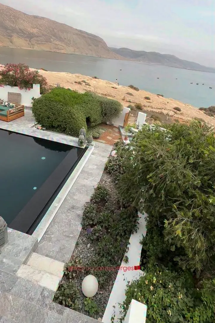 Infinity pool overlooking a rocky bay by the ocean